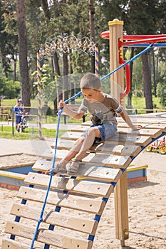 Boy 4 years on the playground. Active four-year-old child playing at a playground