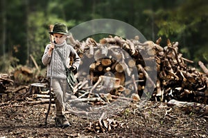 The boy, 5 years old, looks like a trapper, wanderer, lumberjack.