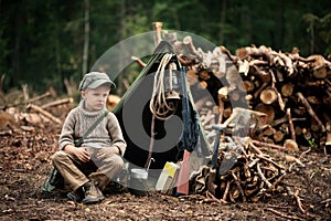 The boy, 5 years old, looks like a trapper, wanderer, lumberjack.