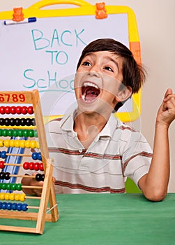 Boy with abacus screaming loudly