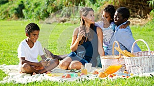 Boy addicting in phone on family picnic