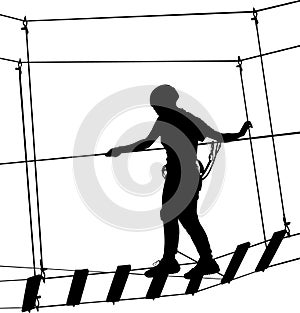 Boy in adventure park rope ladder. Silhouette Adventure. Extreme sportsman took down with rope. Sport weekend action in adventure photo