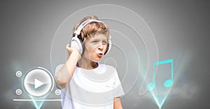 Boy against grey background with headphones and music player icons