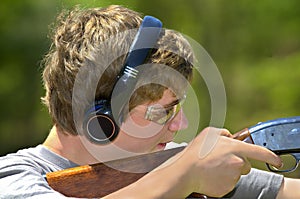 Boy Aiming Shotgun photo