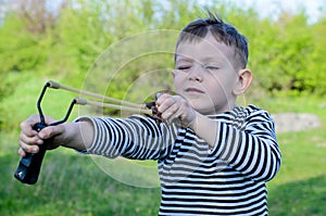 Boy Aiming Sling Shot