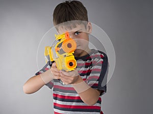 Boy aiming with toy gun