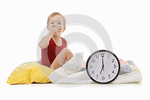 Boy with alarm clock in the bed , wake up concept