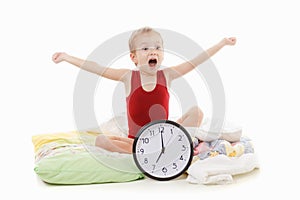Boy with alarm clock in the bed , wake up concept