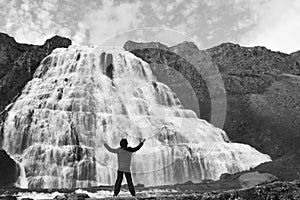 A boy alone in front of the waterfall of Iceland - Europe