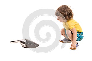 Boy amazed by hand-held vaccum cleaner