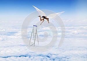 Boy with Angel Wings flying, jumping from the stairs in the sky