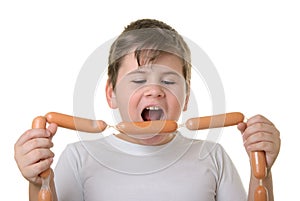 Boy with appetite bites sausages