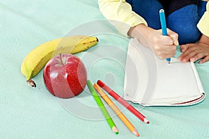 Boy with apple and book going back to school white background stock photo