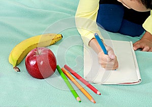 Boy with apple and book going back to school white background stock photo