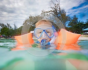 Boy with armbands, mask and snorkel