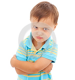 Boy, arms crossed and anger in studio portrait with mental health, anxiety and stress by white background. Child, sad