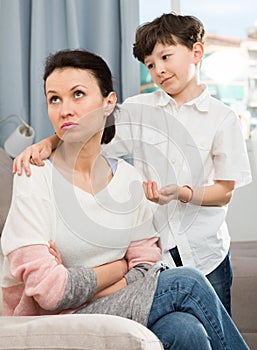 Boy asking for forgiveness from mother