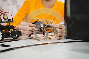 Boy assembles a programmable self-propelled toy