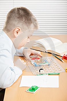 Boy assembling electrical circuit