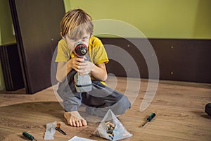 Boy assembling furniture. Boy helping his dad at home. Happy Family concept