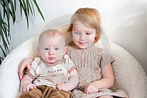 Boy with atopic dermatitis is sitting with his sister