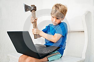 A boy with an ax and a laptop photo