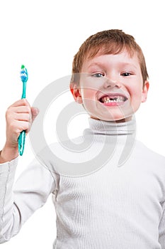 Boy without baby teeth with toothbrush