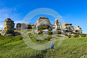 A boy on the background of a picturesque view of the Bakhchisarai sphinxes. Bakhchisarai. May 2021