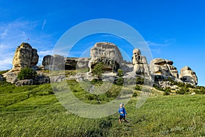 A boy on the background of a picturesque view of the Bakhchisarai sphinxes. Bakhchisarai. May 2021