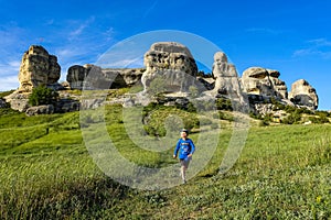 A boy on the background of a picturesque view of the Bakhchisarai sphinxes. Bakhchisarai. May 2021