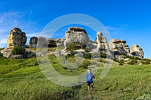 A boy on the background of a picturesque view of the Bakhchisarai sphinxes. Bakhchisarai. May 2021