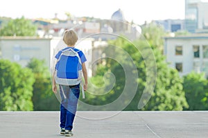 Boy with backpack on city street. Back to school, education, people, travel, leisure concept