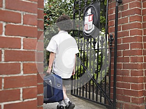 Boy With Backpack Entering School Gate