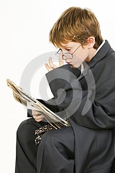 Boy in Baggy Suit Reading Newspaper