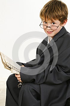 Boy in Baggy Suit Reading Newspaper