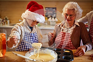 Boy baking cookies with grandmother on Christmas