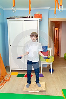 Boy on balancing platform sensory integration photo