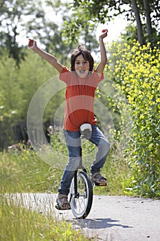 Boy balancing on a unicycle