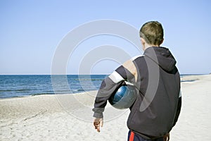 Boy with ball on beach.