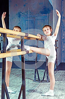 Boy ballet dancer doing exercise at dance class
