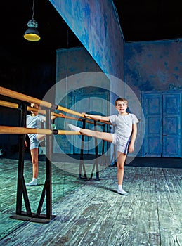 Boy ballet dancer doing exercise at dance class