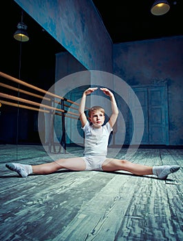 Boy ballet dancer doing exercise at dance class
