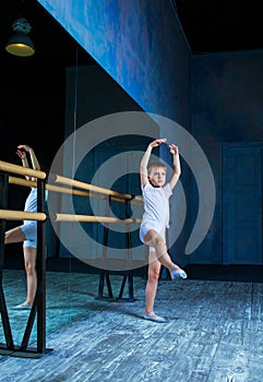 Boy ballet dancer doing exercise at dance class