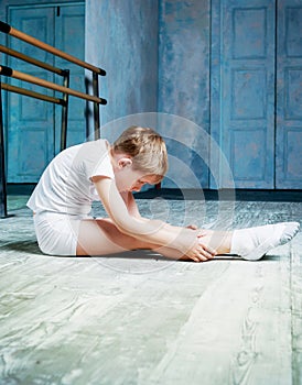 Boy ballet dancer doing exercise at dance class