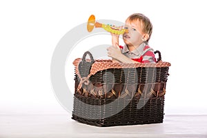 Boy in basket with toy
