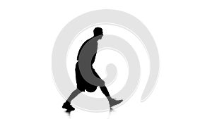 Boy basketball player makes a feint with the ball. Silhouette