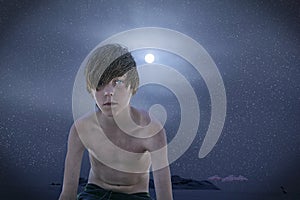 Boy bath into the sun in winter at the beach