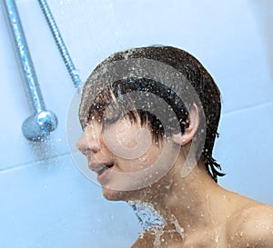 Boy bathing under a shower