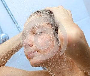 Boy bathing under a shower