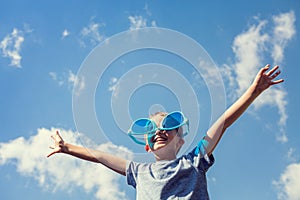 Boy on beach with big sunglasses enjoying the sun